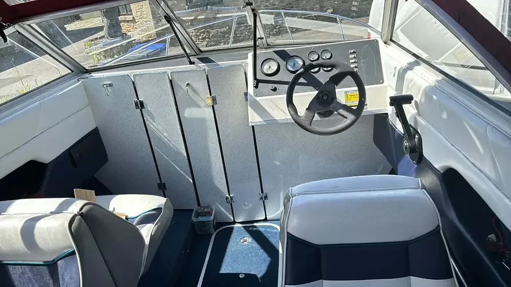 Boat cockpit interior with fitted cabinetry and seating