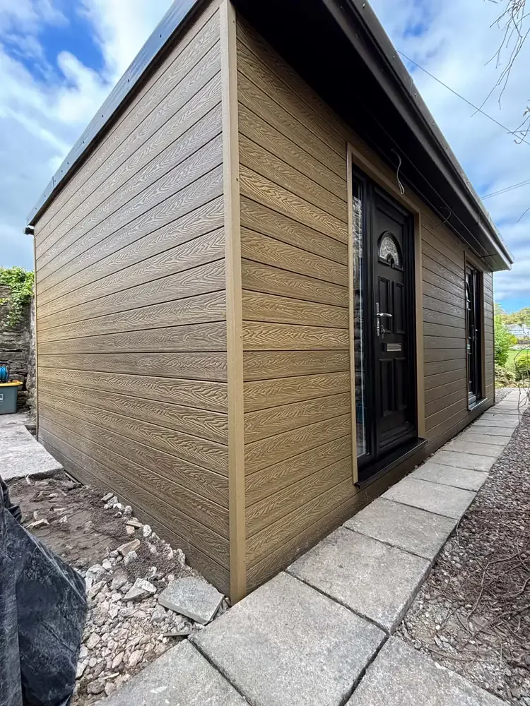 Brown-clad garden room with glazed doors