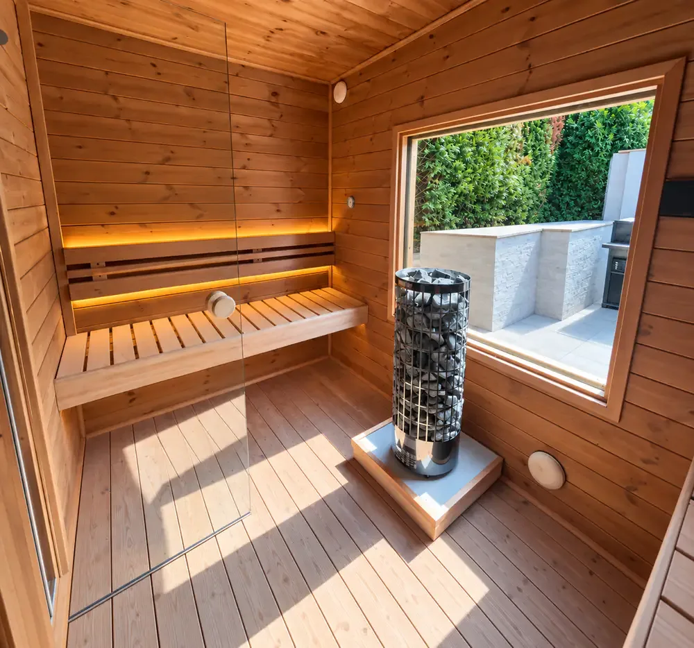 Timber sauna interior with benches, heater and large window