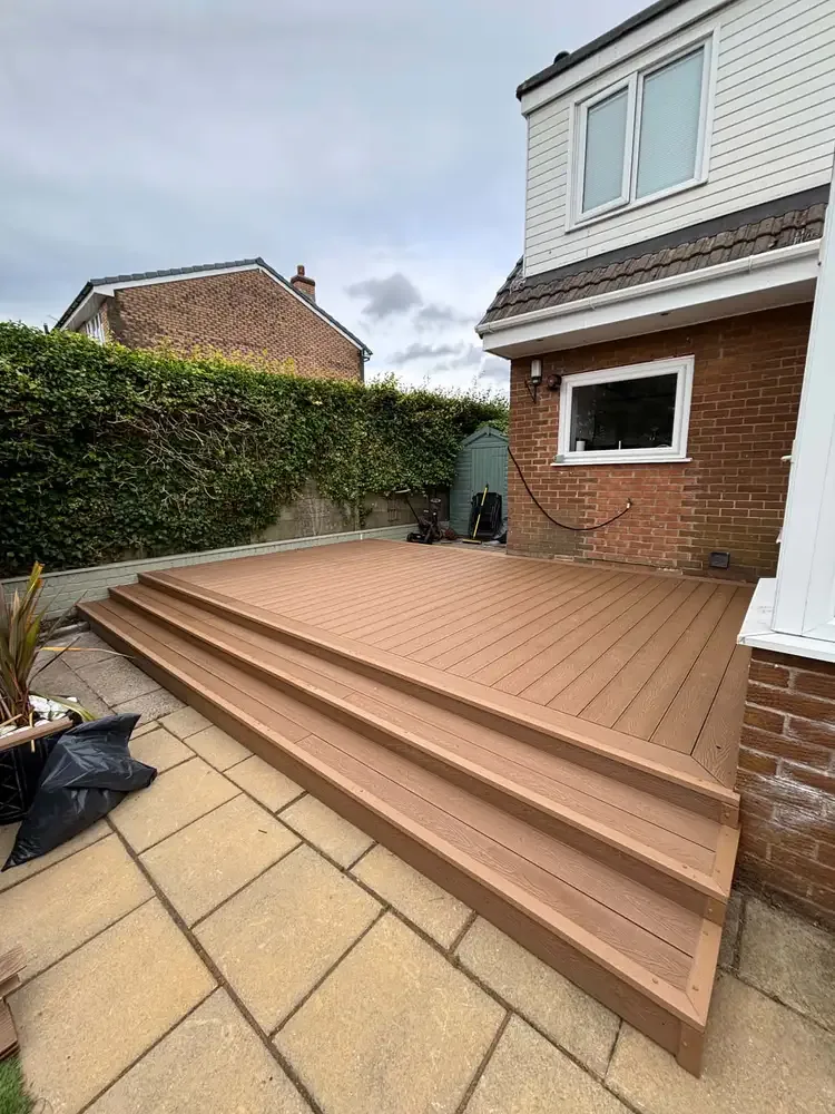 Composite decking with broad steps into a garden